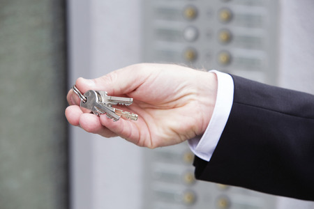 hand of a businessman holding keys