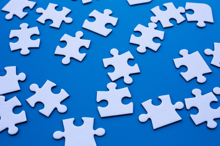 white puzzle on blue tableの写真素材