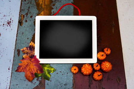 blank chalk board with pumpkins and leaves