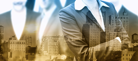 double exposure of group of businesspeople and cityscapeの写真素材