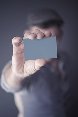 stylish handsome man showing an empty businesscardの写真素材