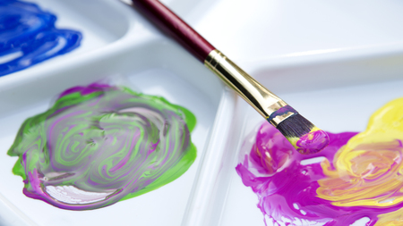 closeup of brush and paint with color paletteの写真素材