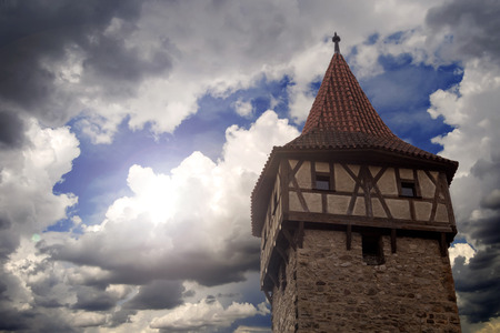 closeup of an old medieval tower and cloudy skyの写真素材