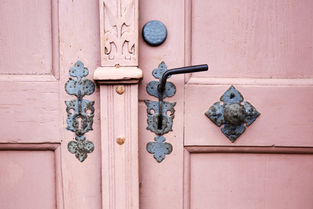closeup of an old wooden door with handle and doorknobの写真素材
