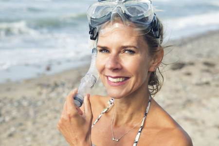 portrait of beautiful woman on the beach with swimming gogglesの写真素材