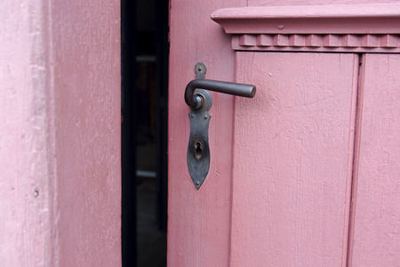 closeup of rustic red door with old doorhandleの写真素材
