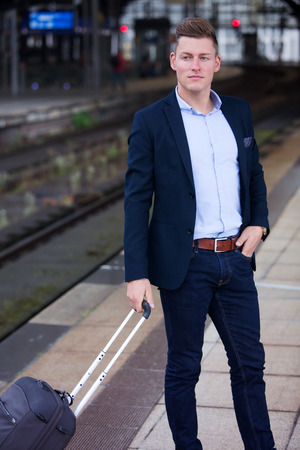 handsome businessman waiting for the trainの写真素材
