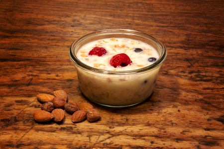 glass bowl with cereal and milk on rustic wooden tableの写真素材