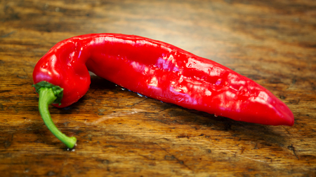 close up of red chili on a rustic wooden tableの写真素材