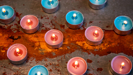 many candles on a rustic wooden tableの写真素材