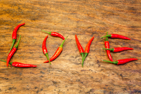 chili as letters for love on rustic wooden tableの写真素材