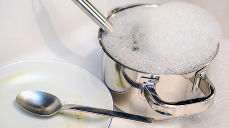 close up of dirty dishes in a kitchen sinkの写真素材