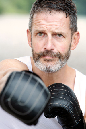 portrait of handsome bearded man with boxing glovesの写真素材