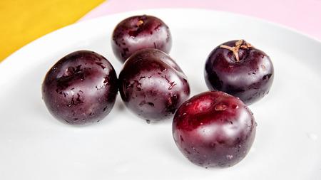 group of fresh plume on a white plateの写真素材