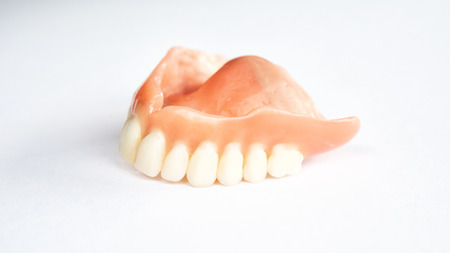 closeup of dental prosthesis on a white backgroundの写真素材