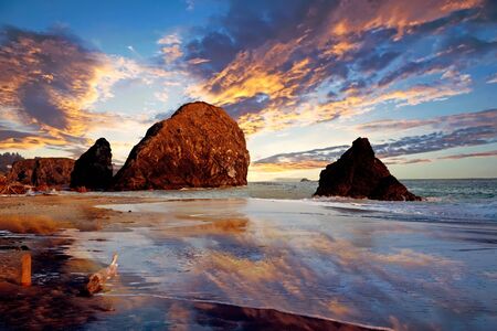 dramatic view of beach in brookings in oregon at sunsetの写真素材