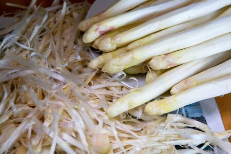 close-up of aspaargus and its peel on tableの写真素材