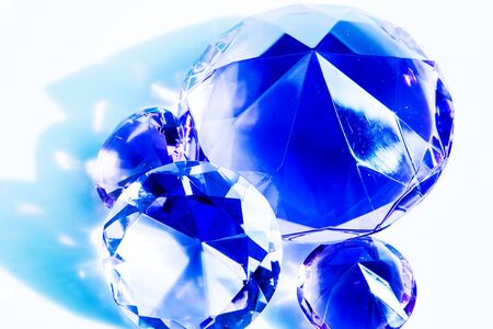 Close-up of blue shiny diamonds on white backgroundの写真素材