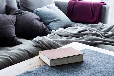 ook on table in living room next to a sofaの写真素材