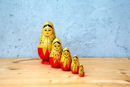 group of russian dolls on wooden table on grey backgroundの写真素材