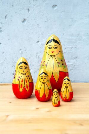 group of russian dolls on wooden table on grey backgroundの写真素材
