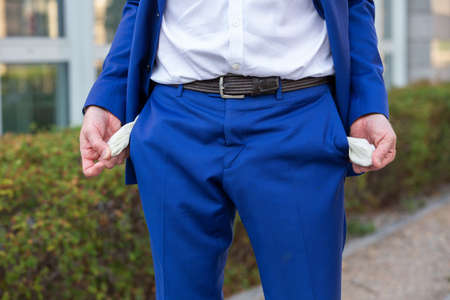 close-up of businessman in blue pants showing his empty pocketsの写真素材