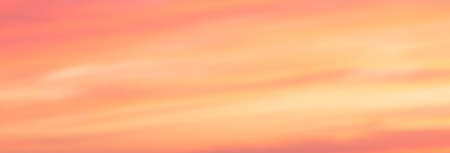 banner of colorful sky at sunset in orange and yellow with soft cloudsの写真素材