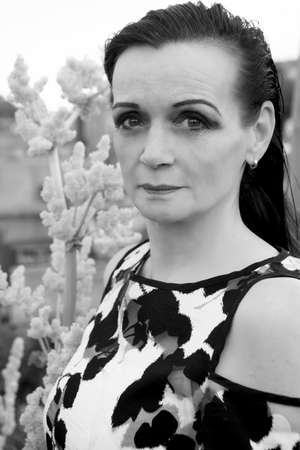 portrait of beautiful woman in her 50s. black and white photoの写真素材