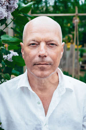 portrait of handsome man in his 50s standing outdoors in natureの写真素材