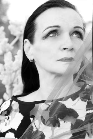 portrait of beautiful woman in her 50s. black and white photoの写真素材