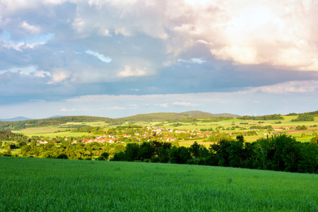 panoramic view of fields and meadow and small villageの写真素材