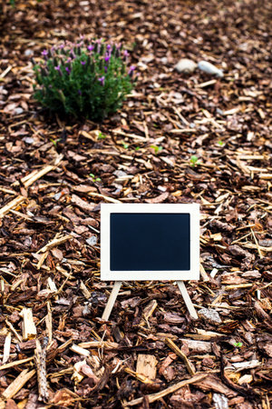small blackboard on a floor with wooden piecesの写真素材