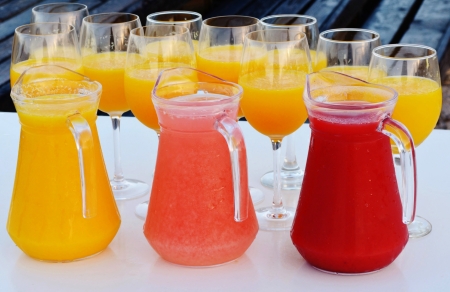 Close up of fresh pressed fruit juice in jugsの写真素材