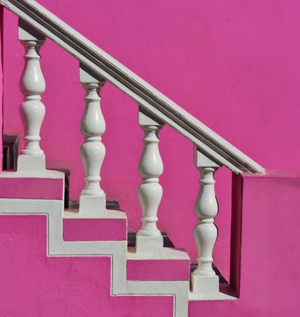 Close up of white Precast Balustrades with pink house wallの写真素材