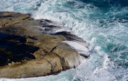 Seascape with rocky shore line and blue sea