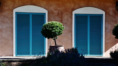 Close up of Provence style house with blue shuttersの写真素材