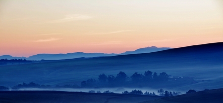 Landscape with mountains and hills in early morning light