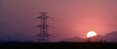 Landscape with power lines at sunriseの写真素材