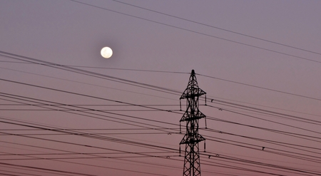 Landscape with power lines and Full Moonの写真素材