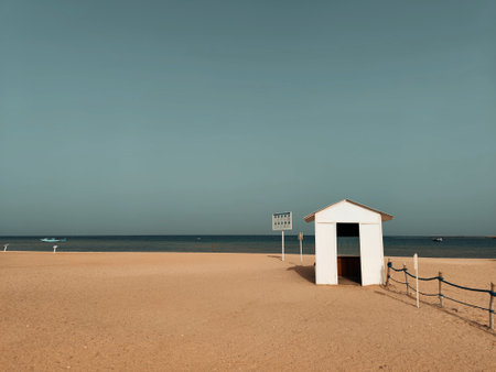 Beach hut on the beach with blue sky and sea in the backgroundの写真素材
