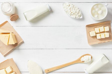 top view of dairy products on a white background. Milk, sour cream, mozzarella, yogurt, cheese assortment. Text space.の写真素材