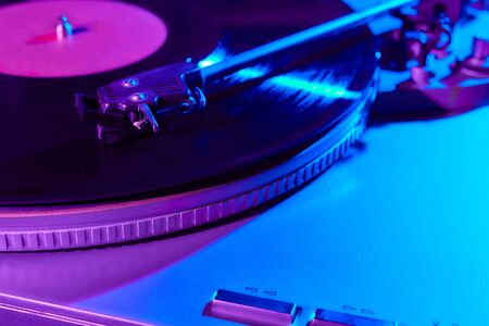 Retro wave, 80s. Record player with a neon light. Vinyl analog turntable. Synthwave and vaporwave concept.の写真素材