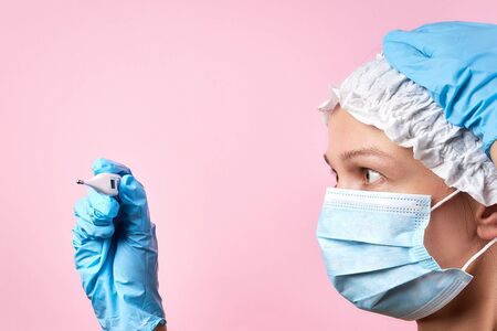 scared woman in medical mask with thermometerの写真素材