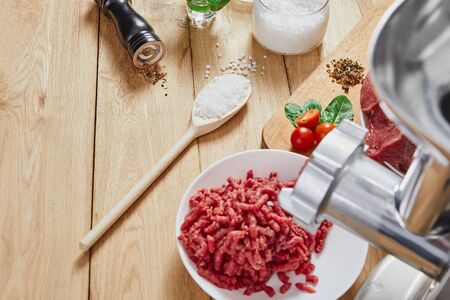 Chopped raw meat and ground beef . The process of preparing forcemeat by a meat grinder. Top view.の写真素材