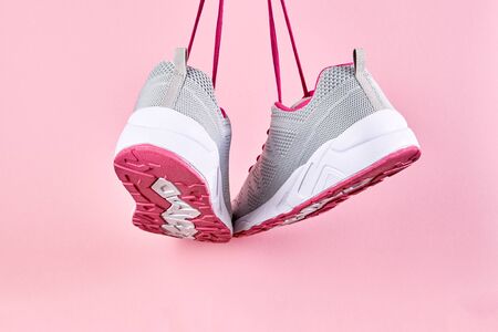 Running sports shoes on pink background, Pair of fashion stylish sneakers. Close up