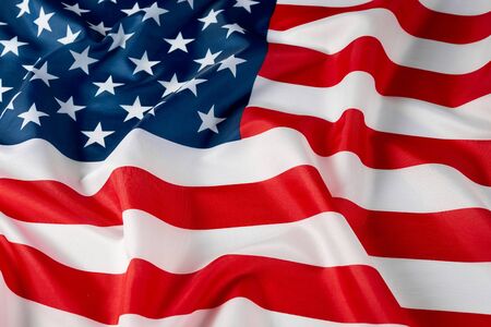 Close up of ruffled American flag. Satin texture curved flag of USA. Memorial Day or 4th of July....