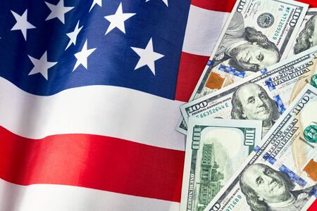 Close up of american flag and dollar cash money. Dollar banknote and United States flag on a...