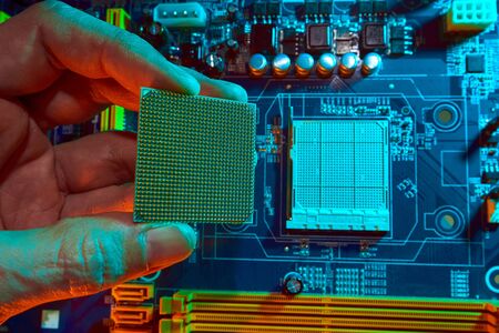 Close up photo of computer engineers hand is holding CPUs computer.