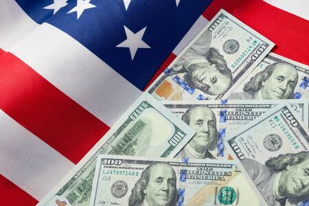 Close up of american flag and dollar cash money. Dollar banknote and United States flag on a background. Economy of USAの写真素材