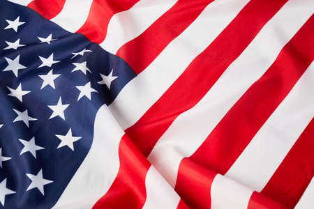 Close up of ruffled American flag. Satin texture curved flag of USA. Memorial Day or 4th of July....